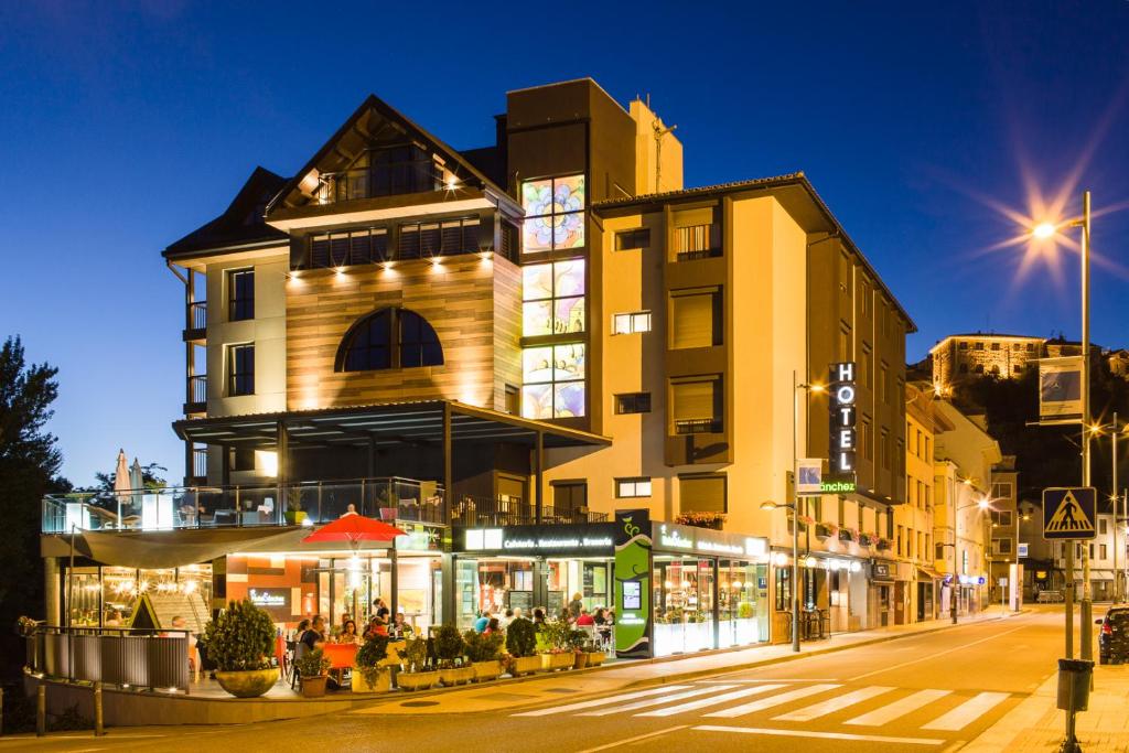 a building on a city street at night at Hotel Sanchez in Aínsa