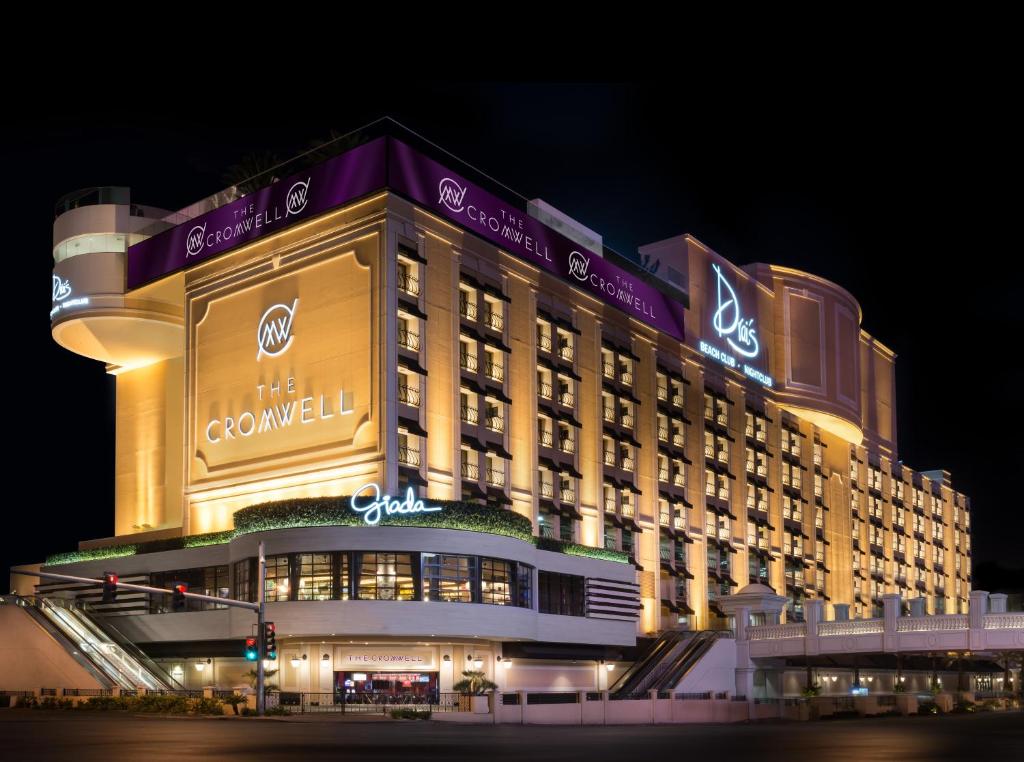 a large building with lights on it at night at The Cromwell Hotel & Casino in Las Vegas