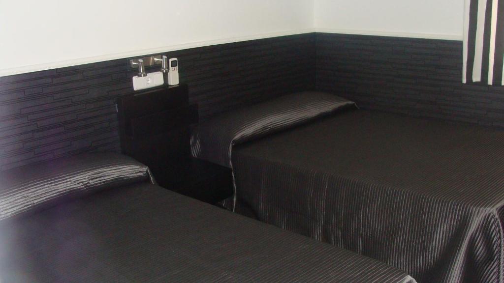 Postel nebo postele na pokoji v ubytování Hostal JQ Madrid 1