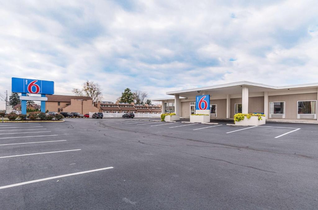 an empty parking lot in front of a dealership at Motel6 Winchester, VA in Winchester