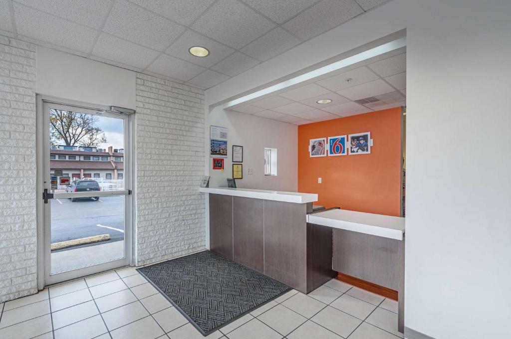 a waiting room with a counter and a window at Motel6 Winchester, VA in Winchester