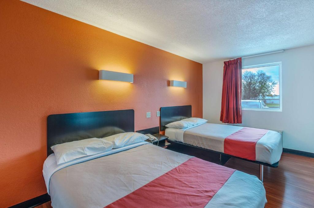 a hotel room with two beds and a window at Motel6 Winchester, VA in Winchester