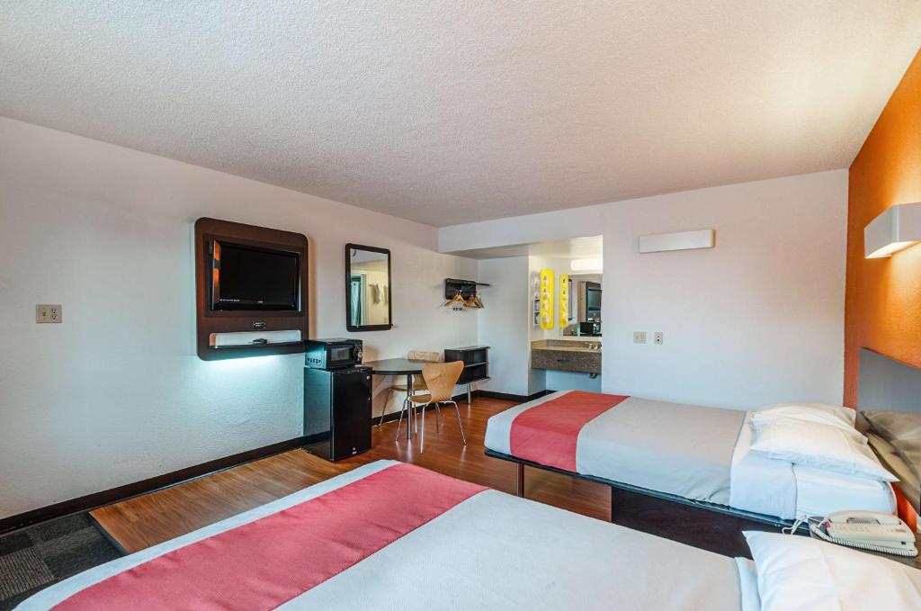 a hotel room with two beds and a flat screen tv at Motel6 Winchester, VA in Winchester