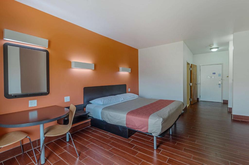 a bedroom with a bed and a desk and a tv at Motel6 Winchester, VA in Winchester
