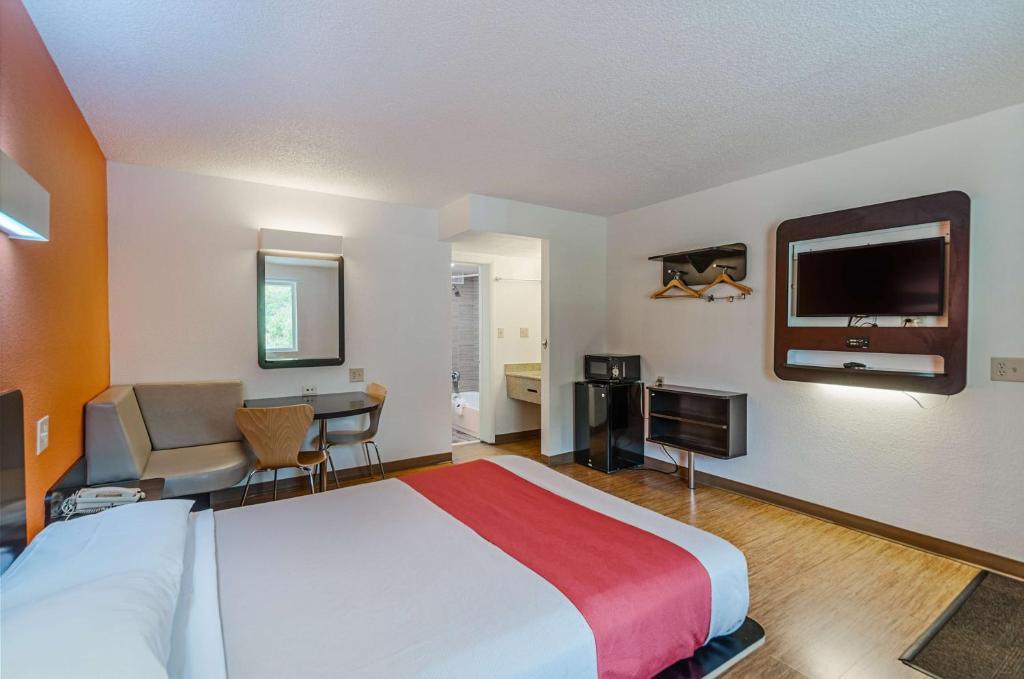 a hotel room with a large bed and a desk at Motel6 Winchester, VA in Winchester