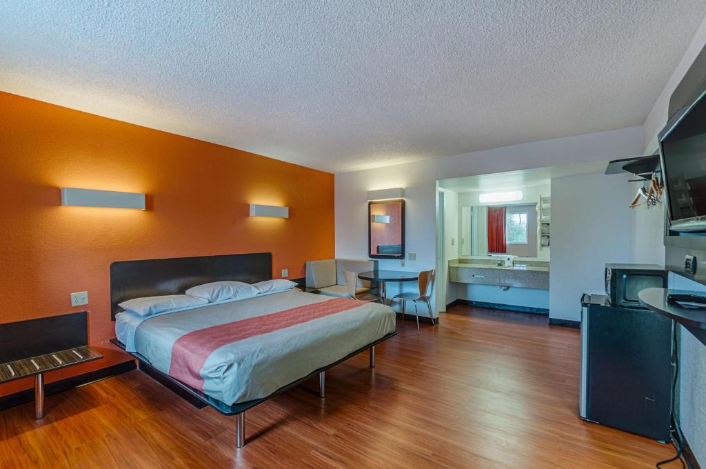 a bedroom with a large bed and a desk at Motel6 Winchester, VA in Winchester