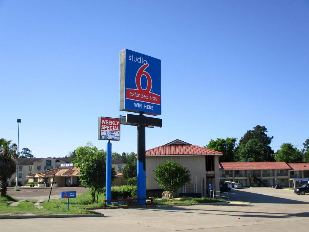 a sign for a mobil gas station in a parking lot at Studio 6-Huntsville, TX in Huntsville