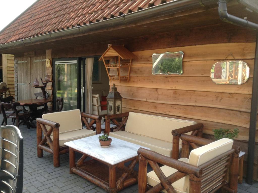 a patio with two chairs and a table at Romala's Home in Kiel