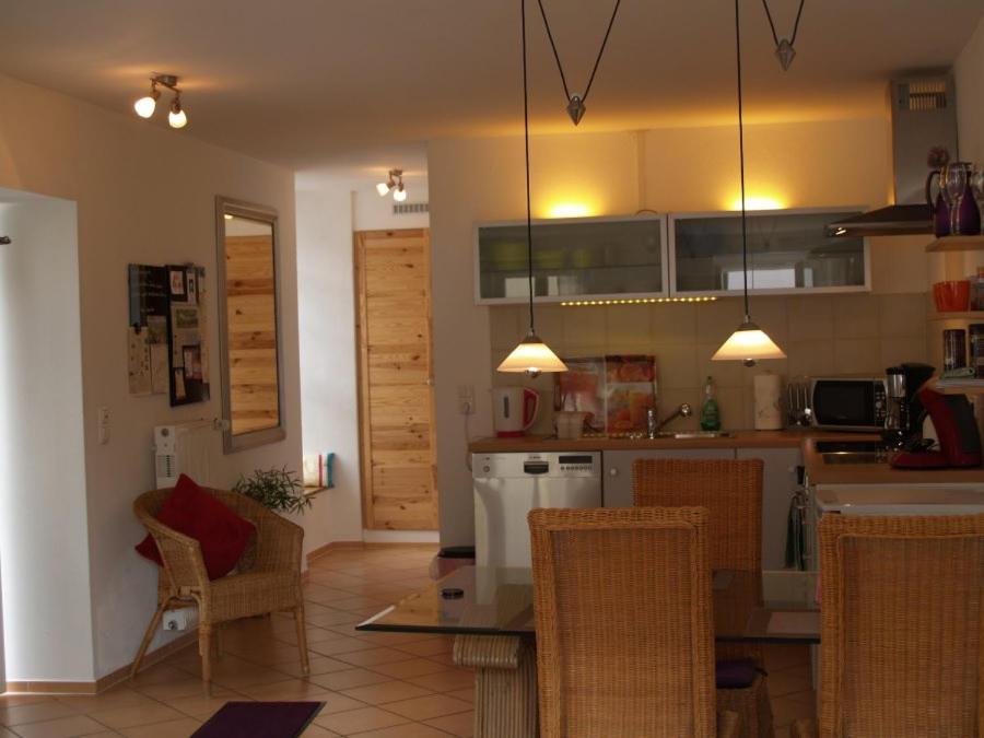 a kitchen with a table and chairs in a room at Ferienwohnung Berweiler in Schweich