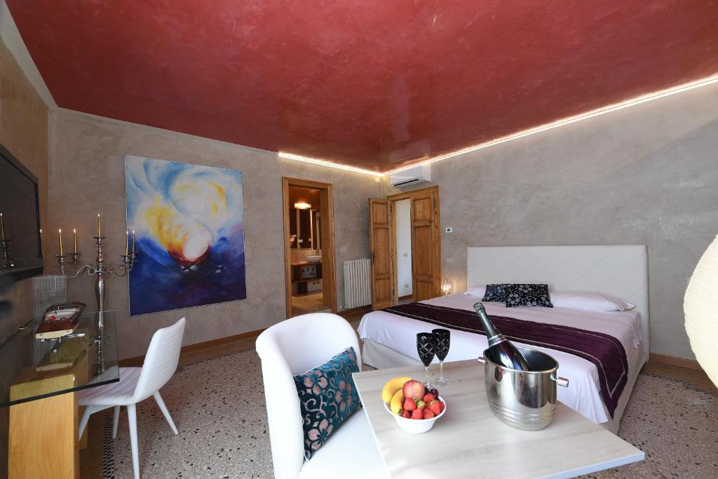 a bedroom with a bed and a table with a bowl of fruit at Amor Mio B&B in Venice