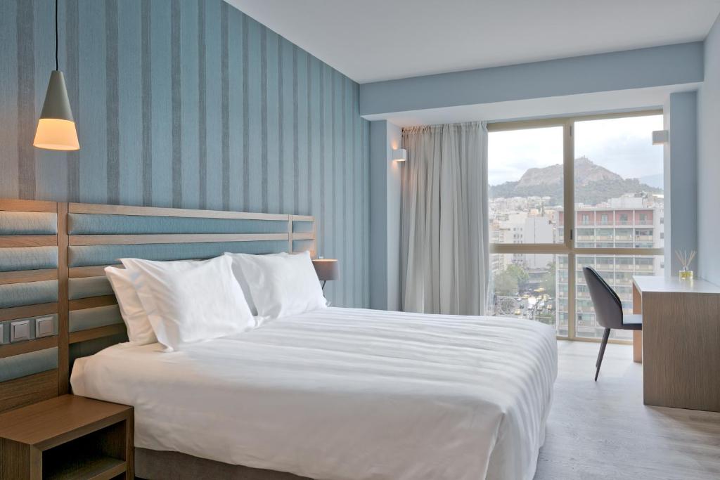 Postel nebo postele na pokoji v ubytování Athens Tiare by Mage Hotels