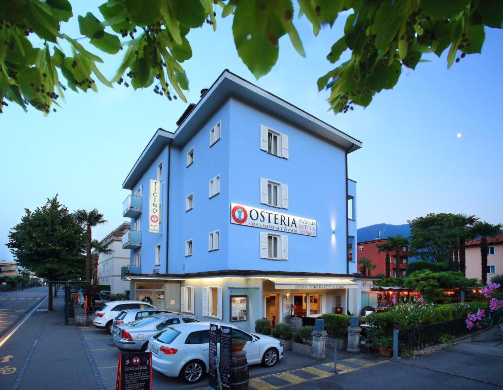 a building with cars parked in a parking lot at Osteria Ticino by Ketty & Tommy in Ascona