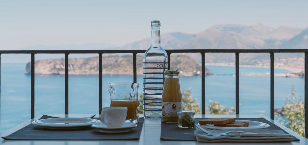 a table with a bottle of wine and a plate of food at Villa Crawford in San Nicola Arcella