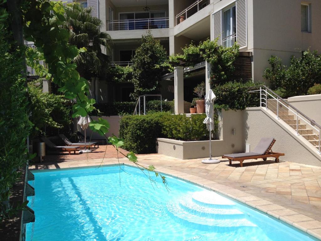 a swimming pool in front of a building at 005 Marina Apartment in Cape Town