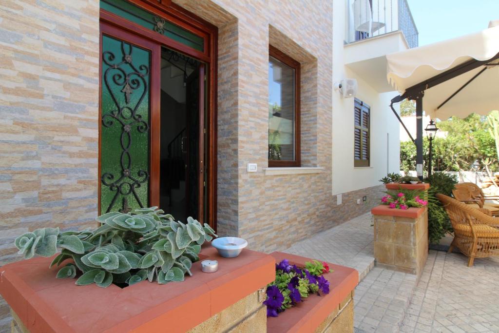 a door to a house with flowers in front of it at B&B Villa Bea in San Vito lo Capo
