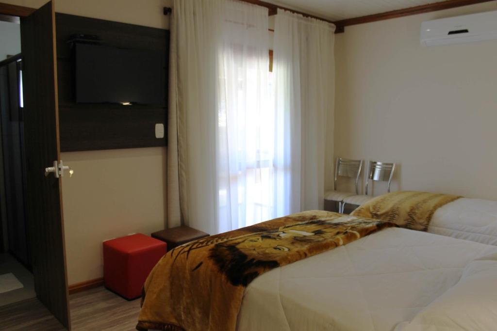 Postel nebo postele na pokoji v ubytování Residencial Aconchego do Lago