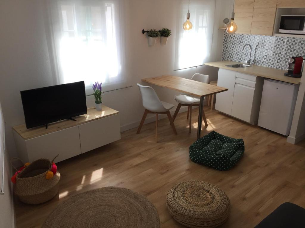 a kitchen with a table and a kitchen with a dining room at Duplex Casco Histórico in Pontevedra