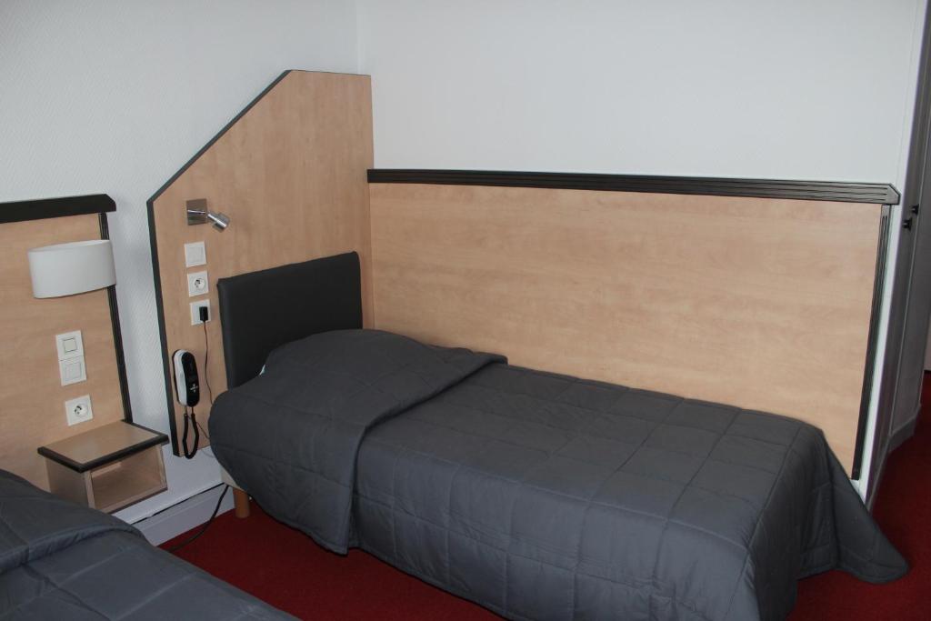 Postel nebo postele na pokoji v ubytování Hôtel de la Meuse