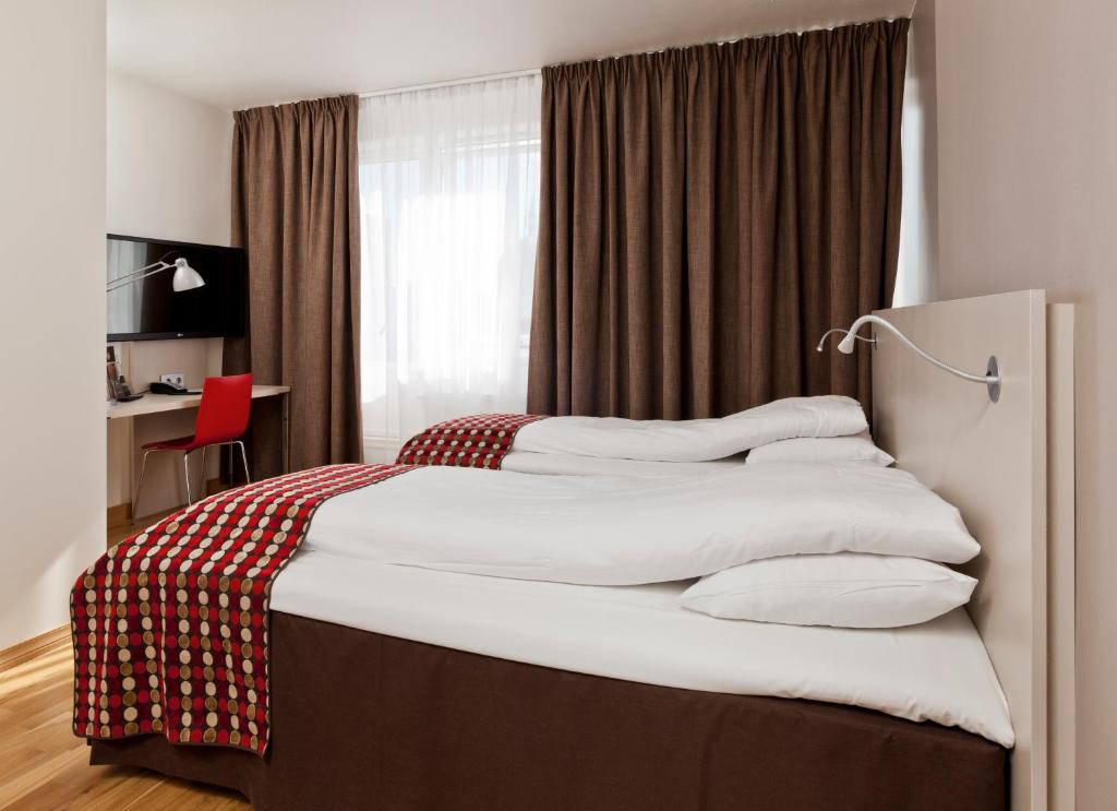 Postel nebo postele na pokoji v ubytování MediInn Hotel Oslo