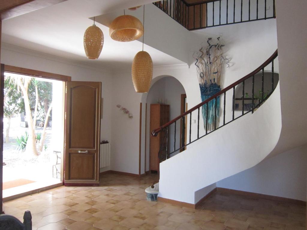 a hallway with a staircase and a door with a vase at Por la zona de Cabo de Gata in Antas