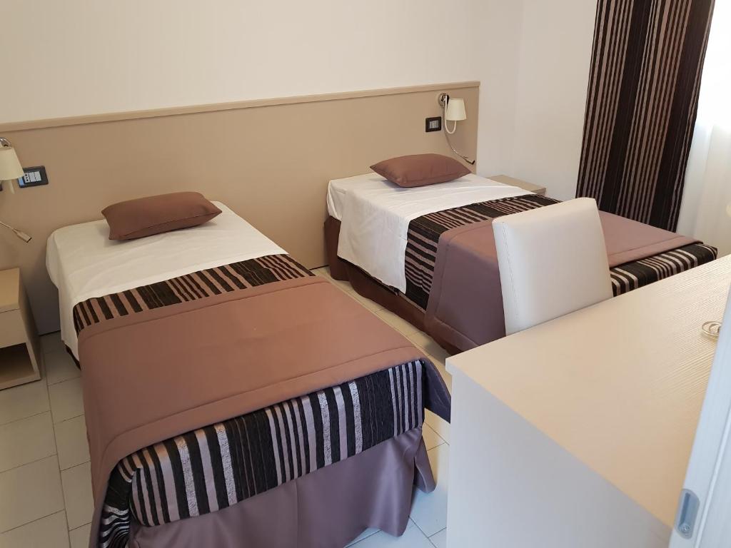 Postel nebo postele na pokoji v ubytování Hotel I Pini