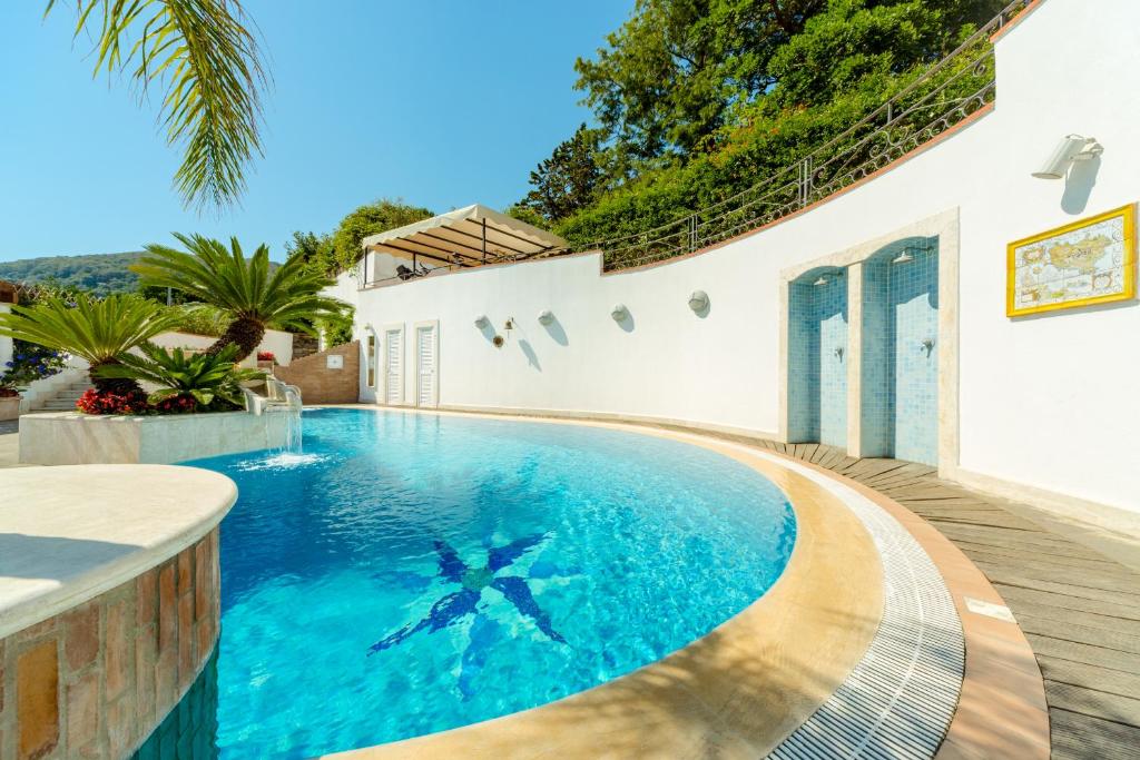 a swimming pool in the middle of a house at Villa Araucaria in Ischia