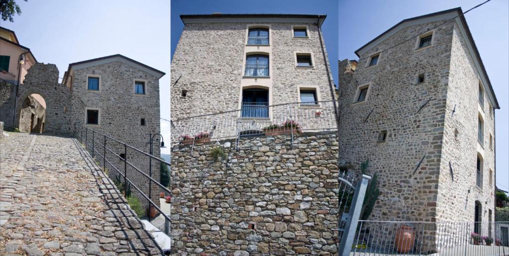 Al Castello Da Annamaria في بيفيرينو: مبنى بحائط حجري بجانب مبنى