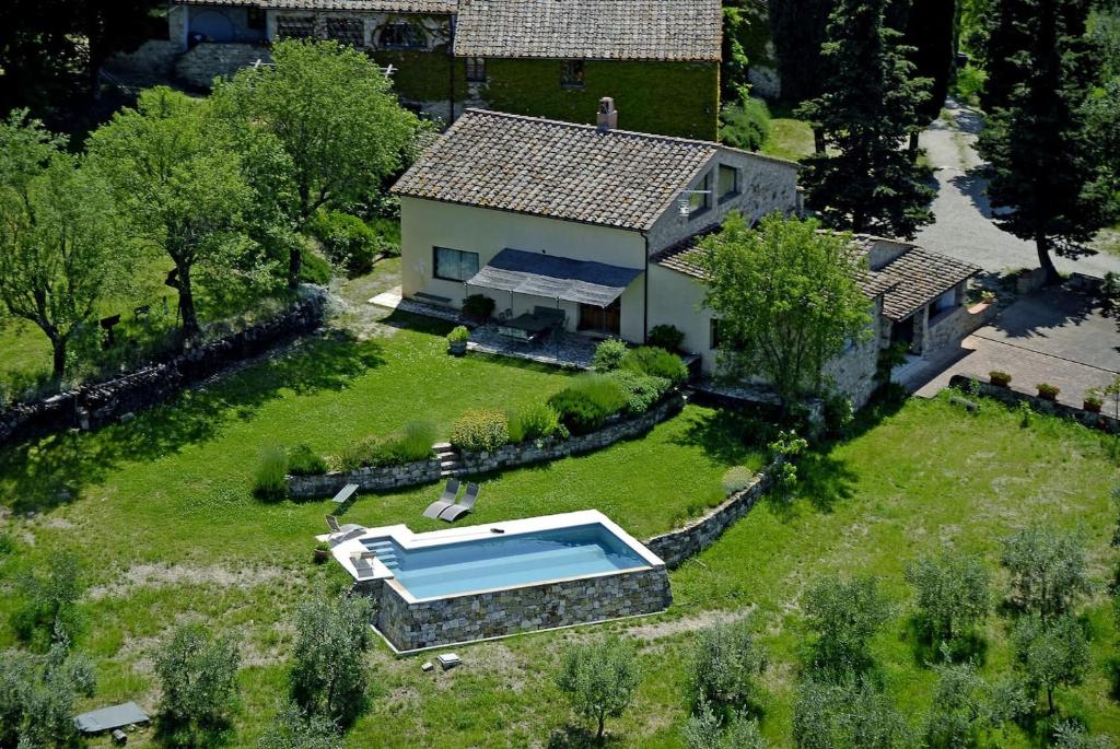 an aerial view of a house with a swimming pool at Montefili in Greve in Chianti