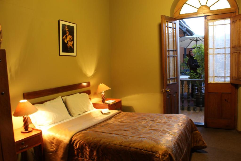 a bedroom with a bed and an open door at El Caminante Class in Arequipa