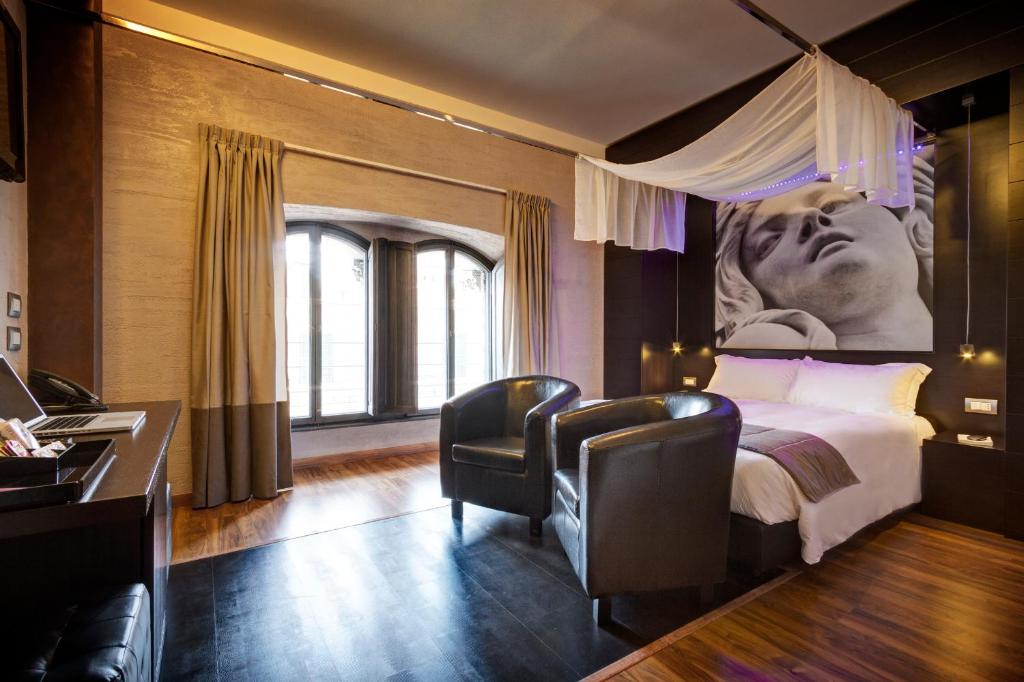 A bed or beds in a room at Dharma Luxury Hotel