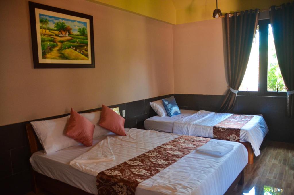 Postel nebo postele na pokoji v ubytování Coco Bungalows Hoi An