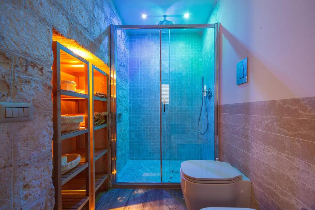 a bathroom with a glass shower and a toilet at B&B Antico Ulivo in Monopoli