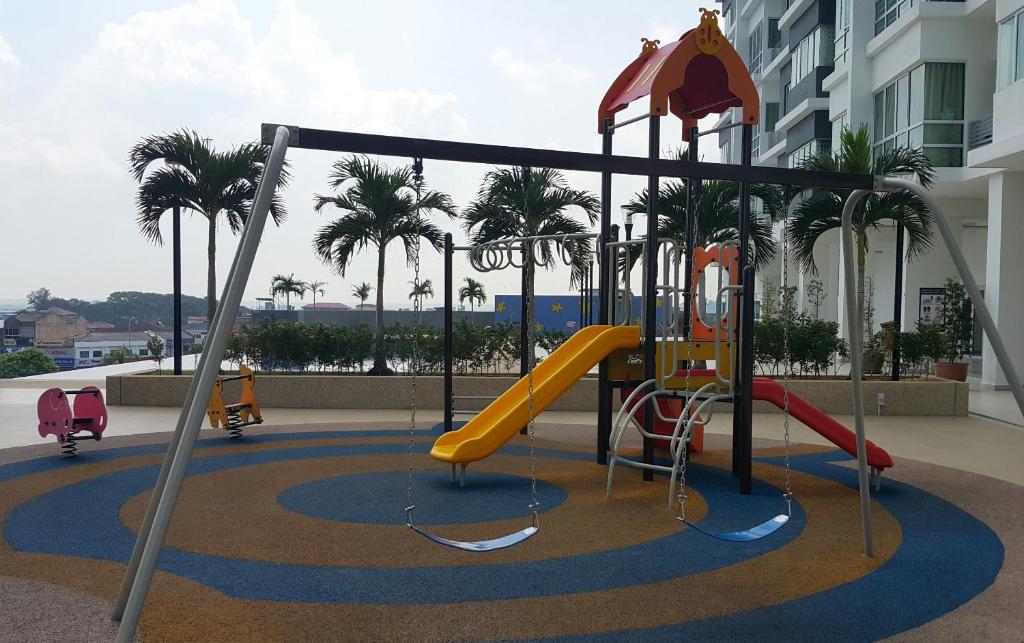 a playground in a building with palm trees at 本店好民宿 in Sekincan