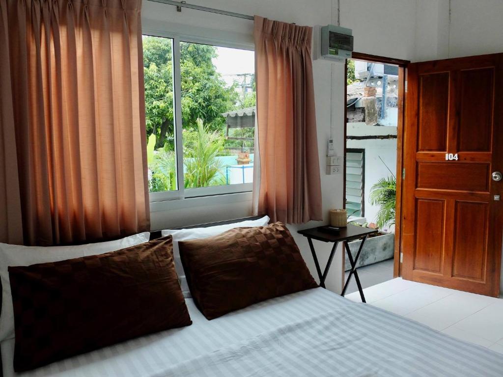 a bedroom with a bed and a large window at D Heart Homestay in Bangkok