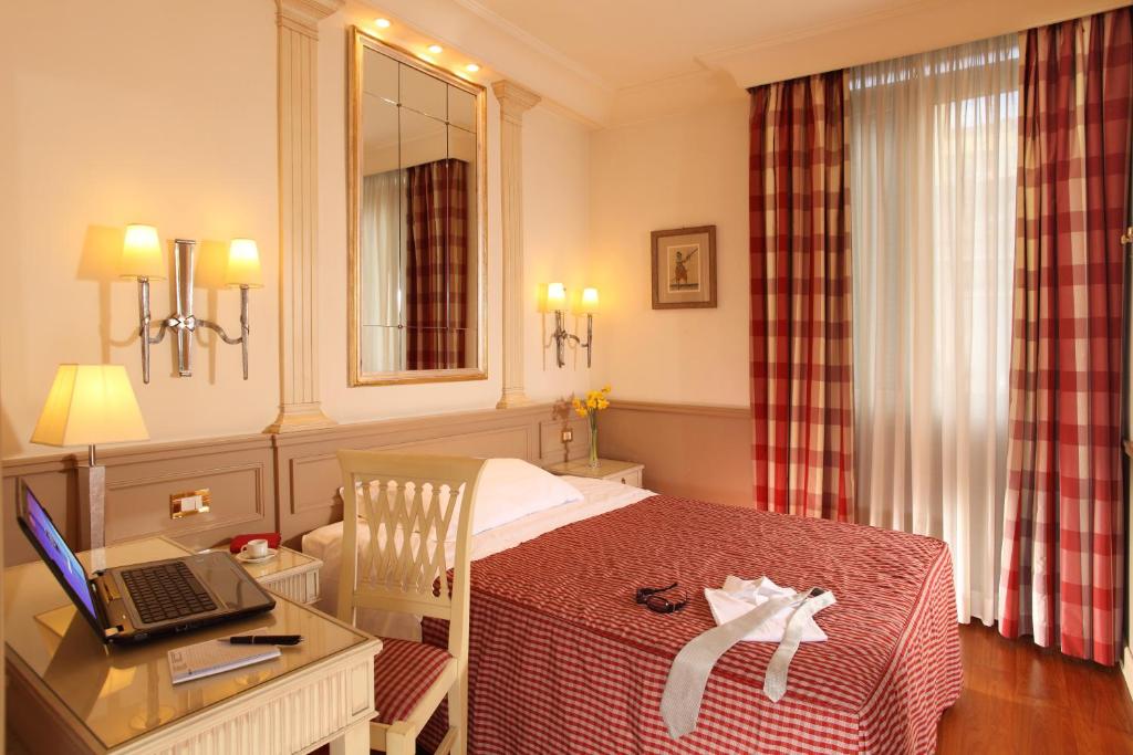 Postel nebo postele na pokoji v ubytování Hotel Villa Glori