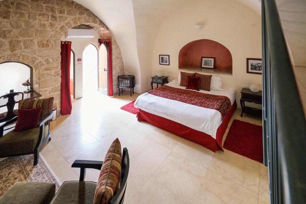 a bedroom with a large bed in a room at Artists' Colony Inn Zefat in Safed