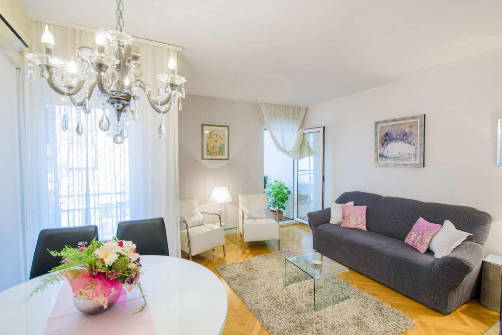 a living room with a couch and a table at Comfortable and Stylish Apartment in Split