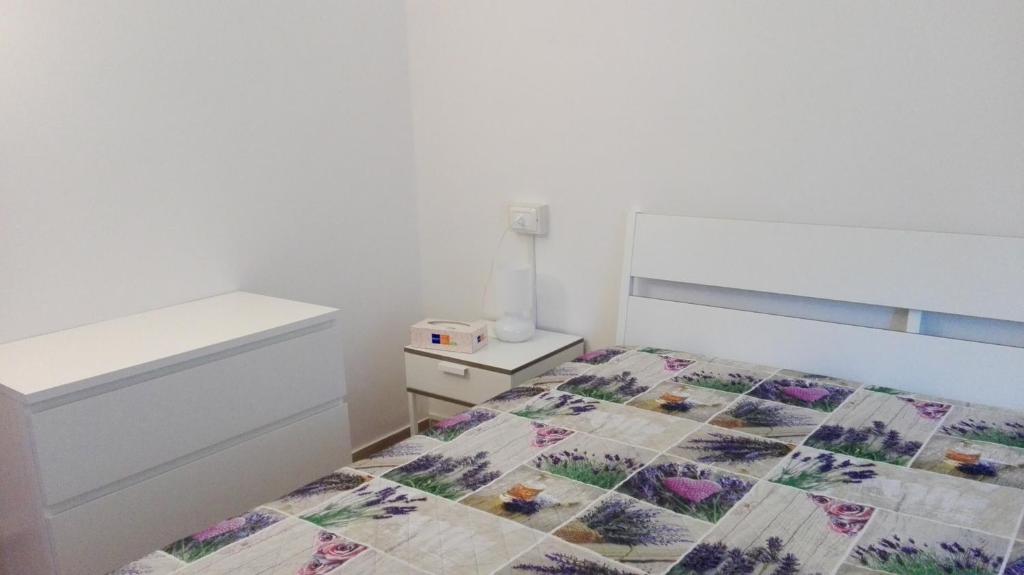 A bed or beds in a room at Appartamenti La Quiete