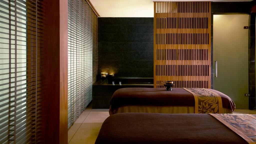 a hotel room with two beds in a room at Anantara Chiang Mai Resort in Chiang Mai