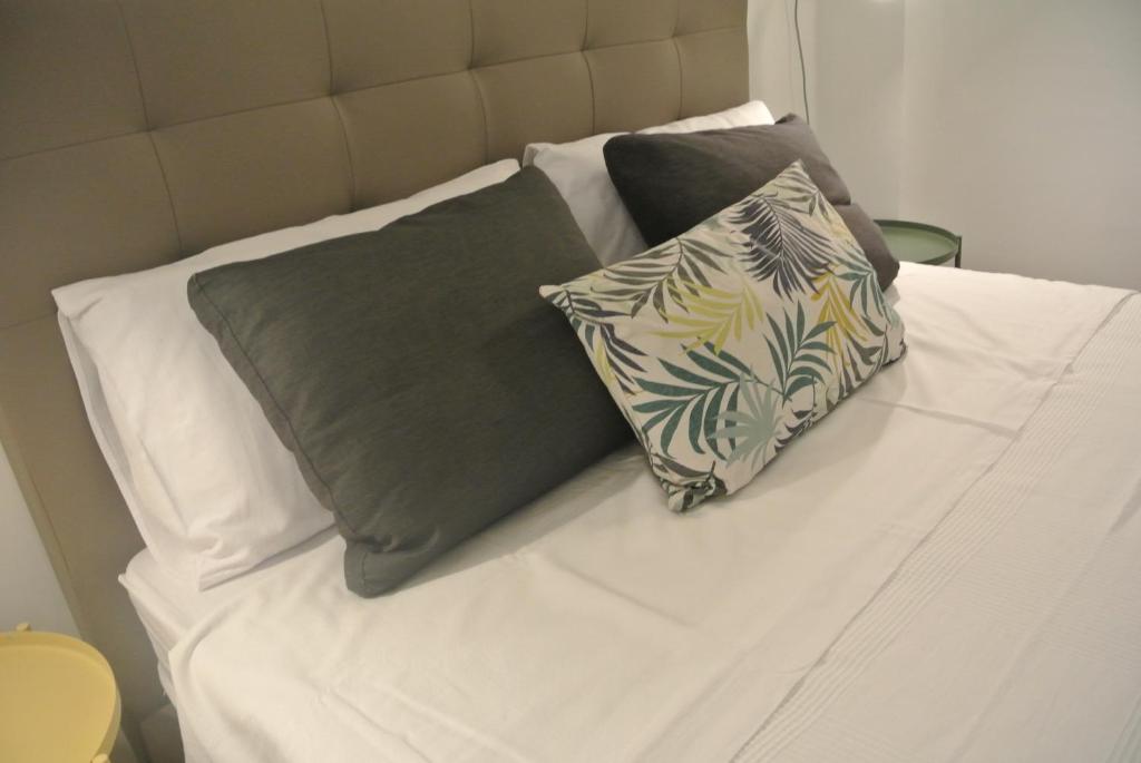 a white bed with two pillows on it at B&B Quattordici in Agropoli