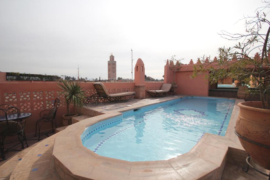 a swimming pool on the roof of a building at Riad Catalina in Marrakech