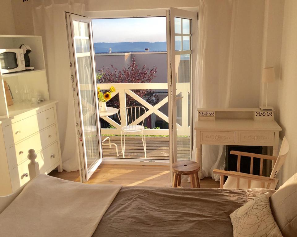 a bedroom with a door open to a balcony at Zimmer mit Bad und Balkon in Widen