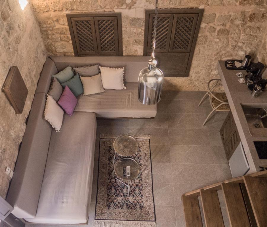 a couch with pillows on it in a room at Trinity Boutique Hotel in Rhodes Town