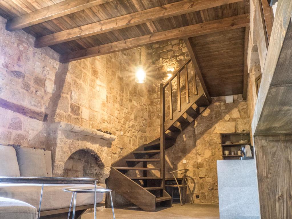 a staircase in a room with a stone wall at Trinity Boutique Hotel in Rhodes Town