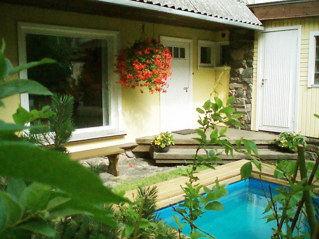 a house with a swimming pool in front of it at Villa Lille in Pärnu