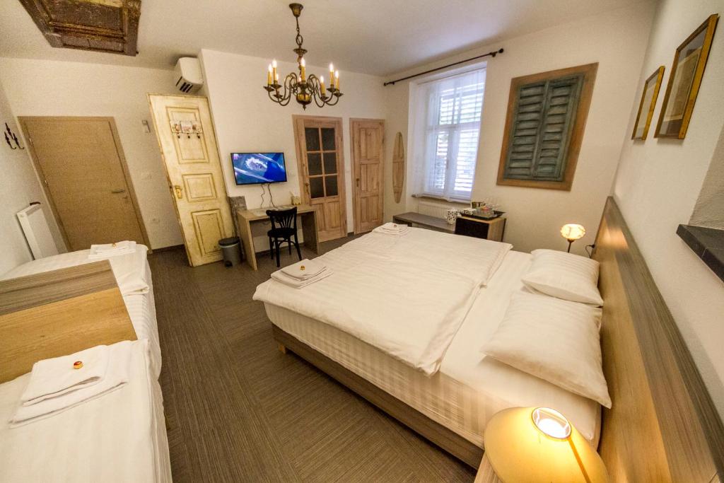 a hotel room with a bed and a desk at OH Apartments & Rooms in Ljubljana