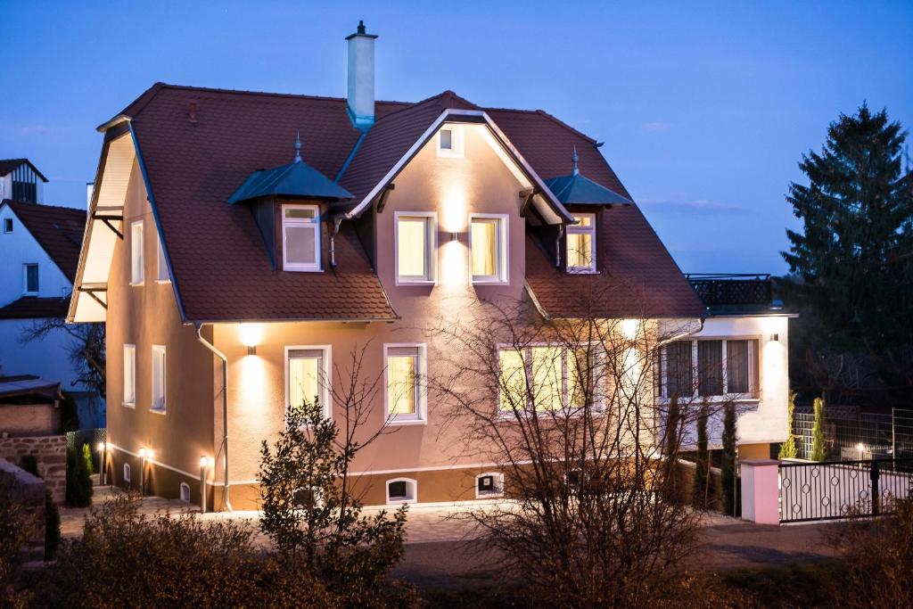 a house with lights on the front of it at Hotel Landgasthof Birkenfelder Hof in Birkenfeld
