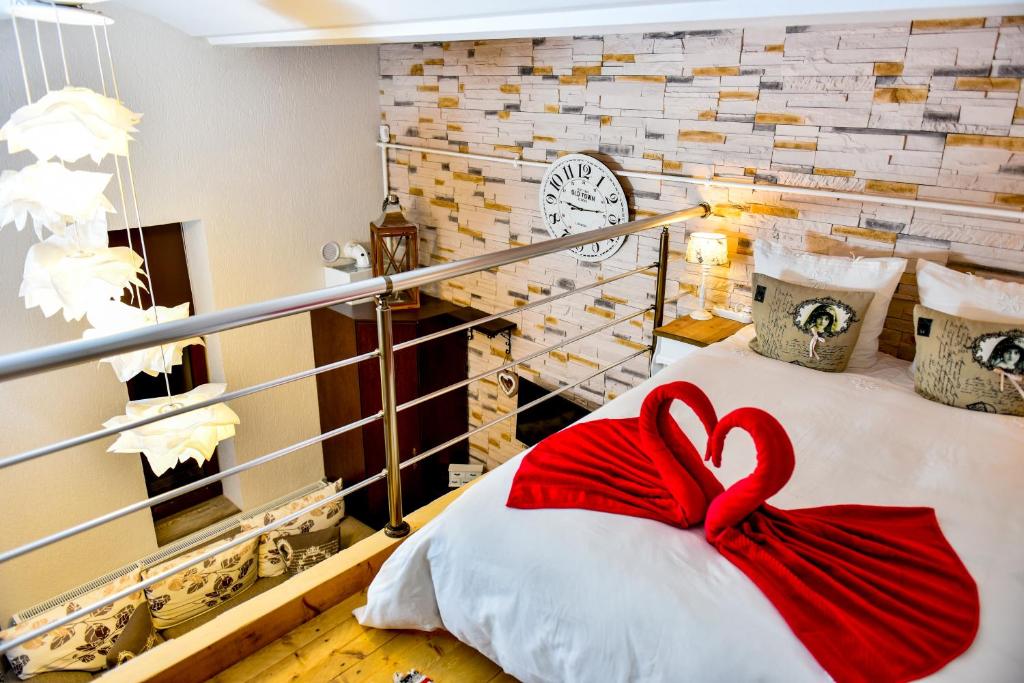 a room with a bed with a red bow on it at Duplex Alexander in Braşov