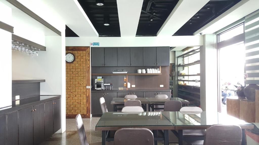 a dining room with a table and some chairs at Sun Fog Hotel in Yuchi
