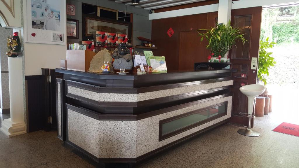 a bar in a room with a counter at Sun Fog Hotel in Yuchi